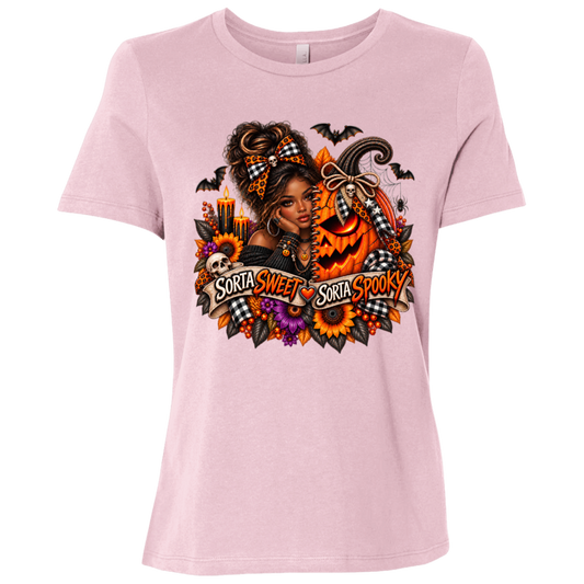 A Pink T-Shirt featuring an African American woman in a glamorous Halloween scene surrounded by a decorated jack-o'-lantern, sunflowers, autumn flowers, candles, bats, skulls, and spiderwebs, with a decorative banner reading “Sorta Sweet Sorta Spooky” on a transparent background