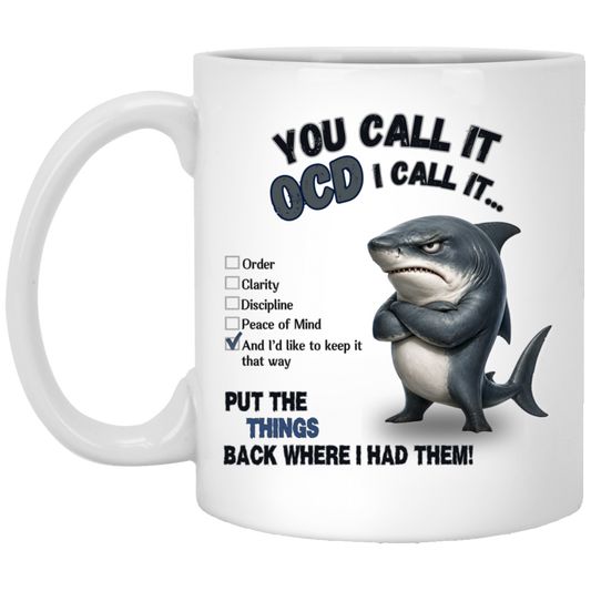 Realistic stern shark with crossed fins beside a checklist reading Order, Clarity, Discipline, Peace of Mind, and “And I’d like to keep it that way.” Text above reads “YOU CALL IT OCD I CALL IT…” and text below reads “PUT THE THINGS BACK WHERE I HAD THEM!” on a transparent background