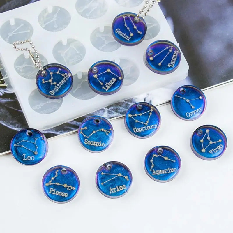 Zodiac-themed using a blue color Resin necklaces plastic mold on a white surface with on a blurred background