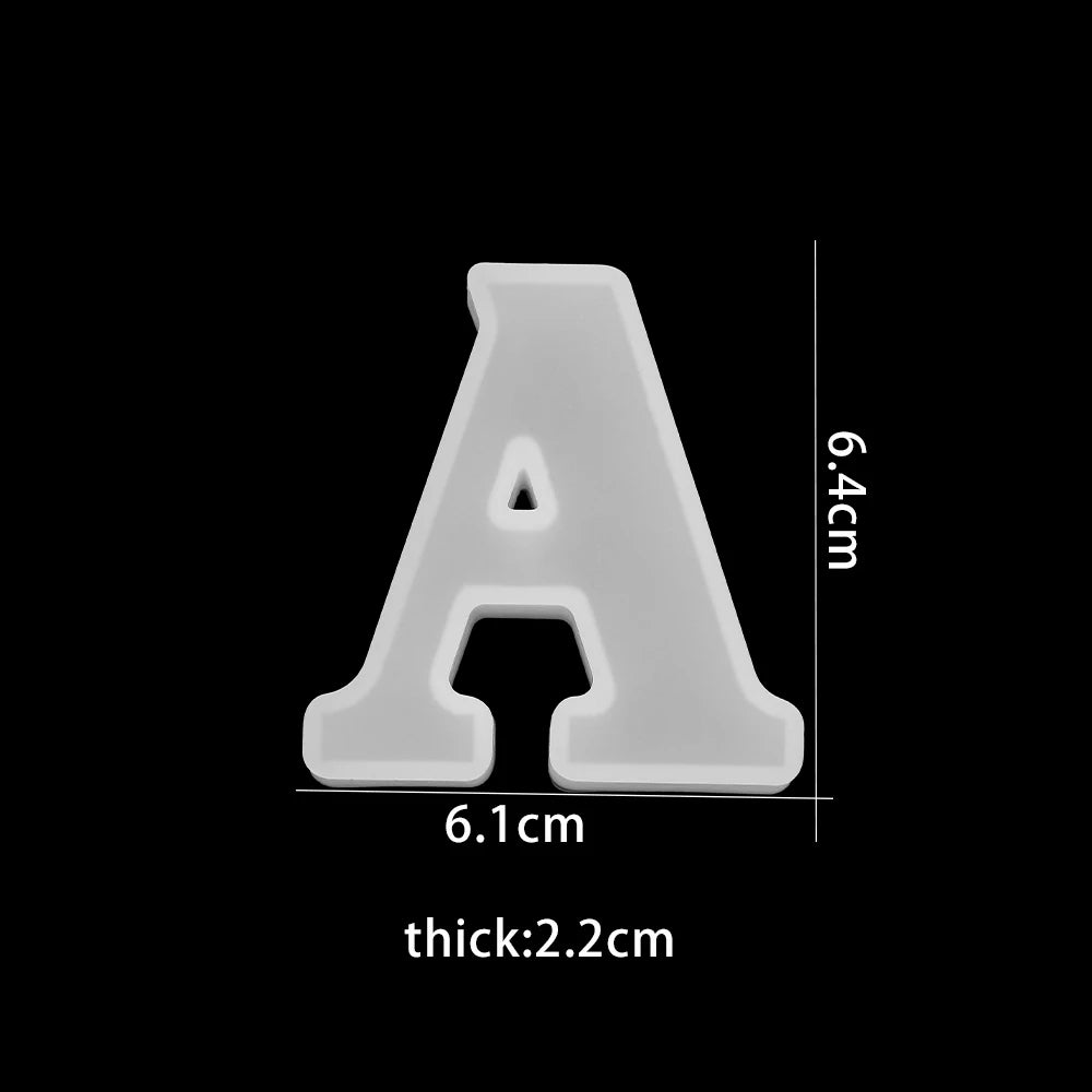 White letter 'A'  with dimensions on a black background 6.1cm wide, 6.4cm high, 2.2cm thick