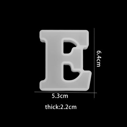 White letter 'E' with dimensions on a black background 5.3cm wide, 6.4cm high, 2.2cm thick