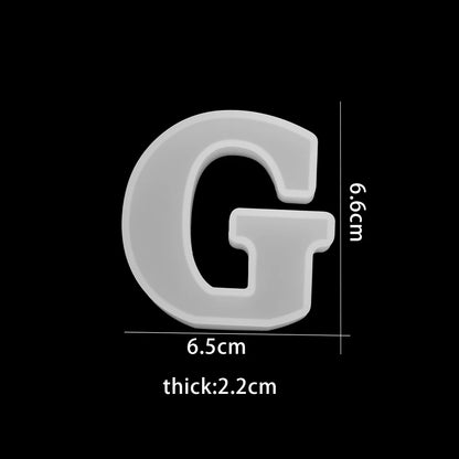White letter 'G' with dimensions on a black background 6.5cm wide, 6.6cm high, 2.2cm thick