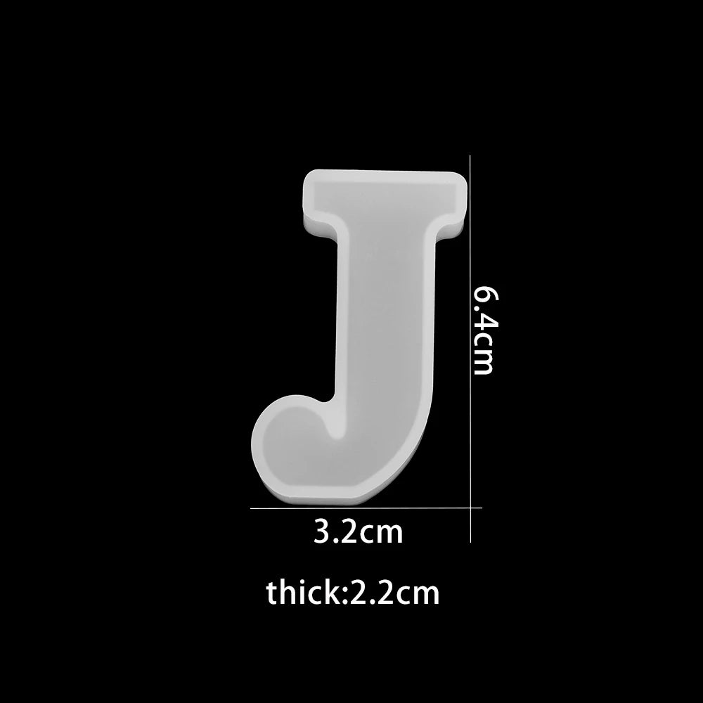 White letter 'J' with measurements on a black background 3.2cm wide, 6.4cm high, 2.2cm thick
