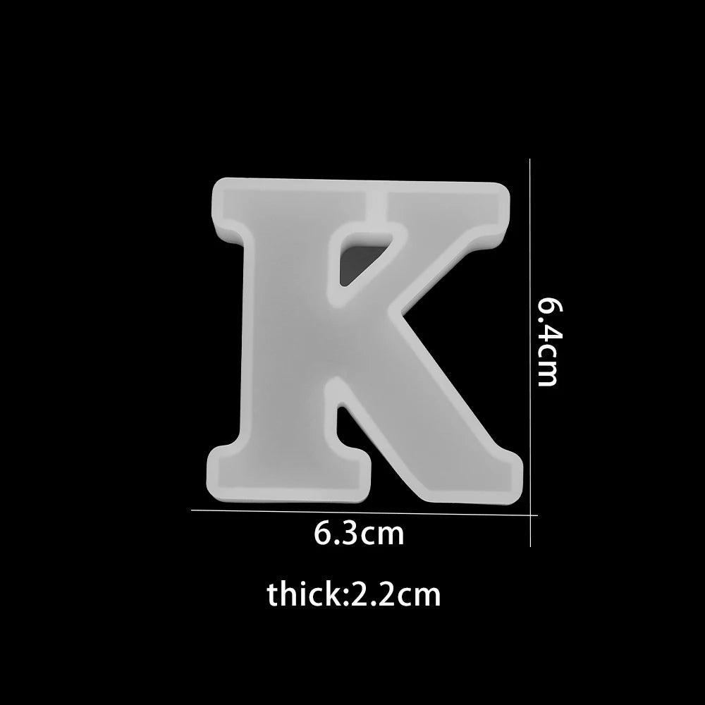 White letter 'K' with dimensions on a white background 6.3cm wide, 6.4cm high, 2.2cm thick