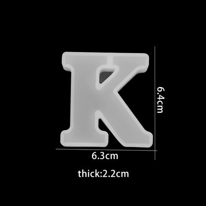 White letter 'K' with dimensions on a white background 6.3cm wide, 6.4cm high, 2.2cm thick