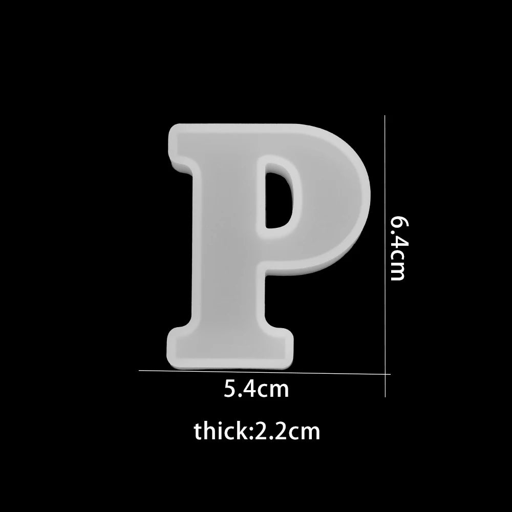 White letter 'P' with measurements on a black background 5.4 wide, 6.4 cm, 2.2 cm thick