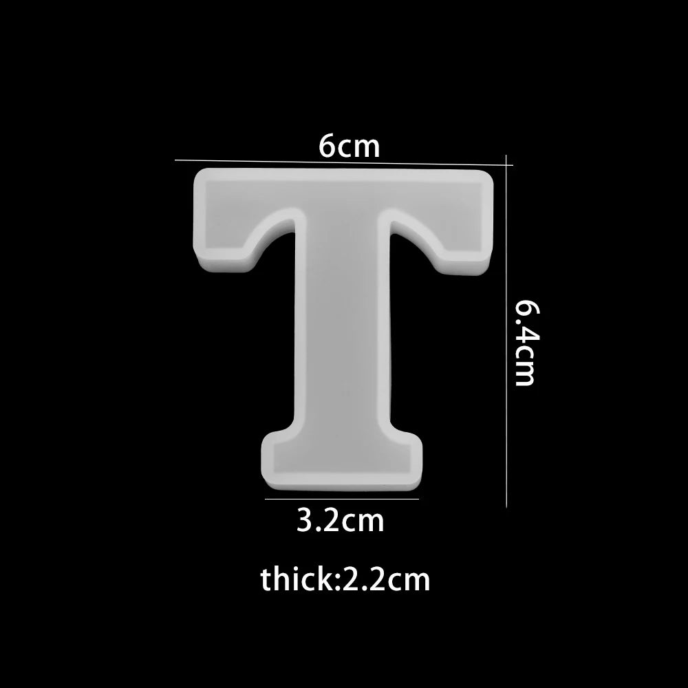 White letter 'T' with dimensions on a black background 3.2cm bottom width, 6cm top with, 6.4cm high, 2.2cm thick