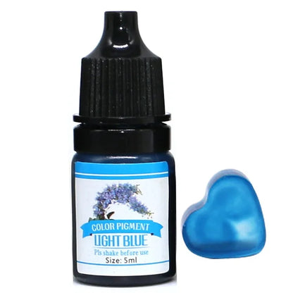 Bottle of light blue color pigment with a heart-shaped container on a white background