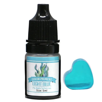 Bottle of light blue color pigment which could be sky blue with a sample heart-shaped application on a white background
