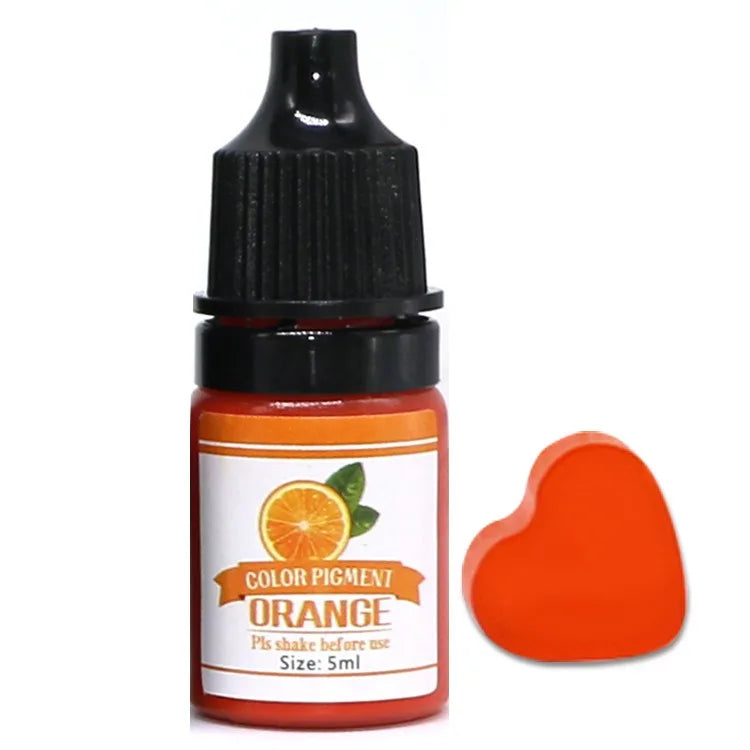Bottle of orange color pigment with a heart-shaped sample on a white background