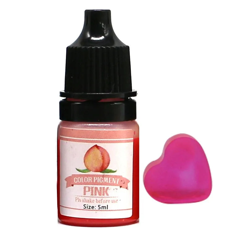 Bottle of Pink color pigment with a heart-shaped pink object on a white background