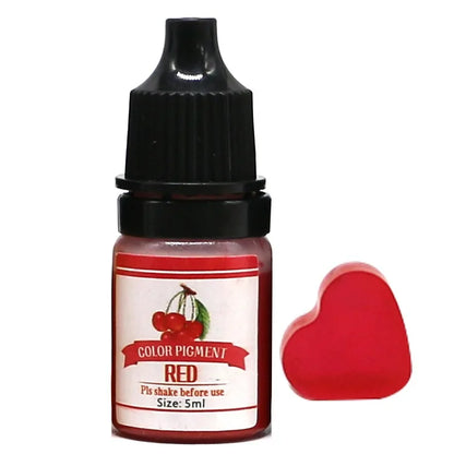 Bottle of red color pigment with a heart-shaped applicator on a white background
