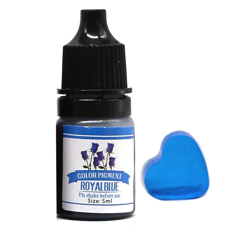 Bottle of royal blue color pigment with a heart-shaped sample on a white background