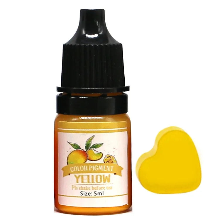 Bottle of yellow color pigment with a heart-shaped sample on a white background