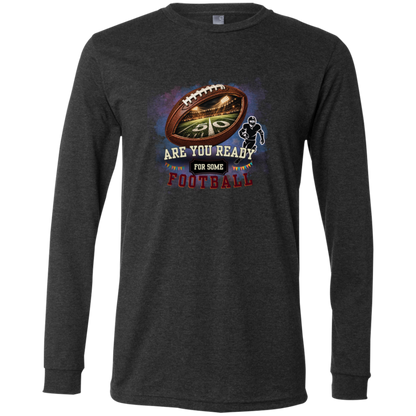 Bold football-themed graphic in Dark Grey Heather featuring a textured brown football with a glowing nighttime stadium and 50-yard line visible inside, a football player silhouette, watercolor background, and the words “ARE YOU READY FOR SOME FOOTBALL” in cream, black, and burgundy collegiate-style lettering.