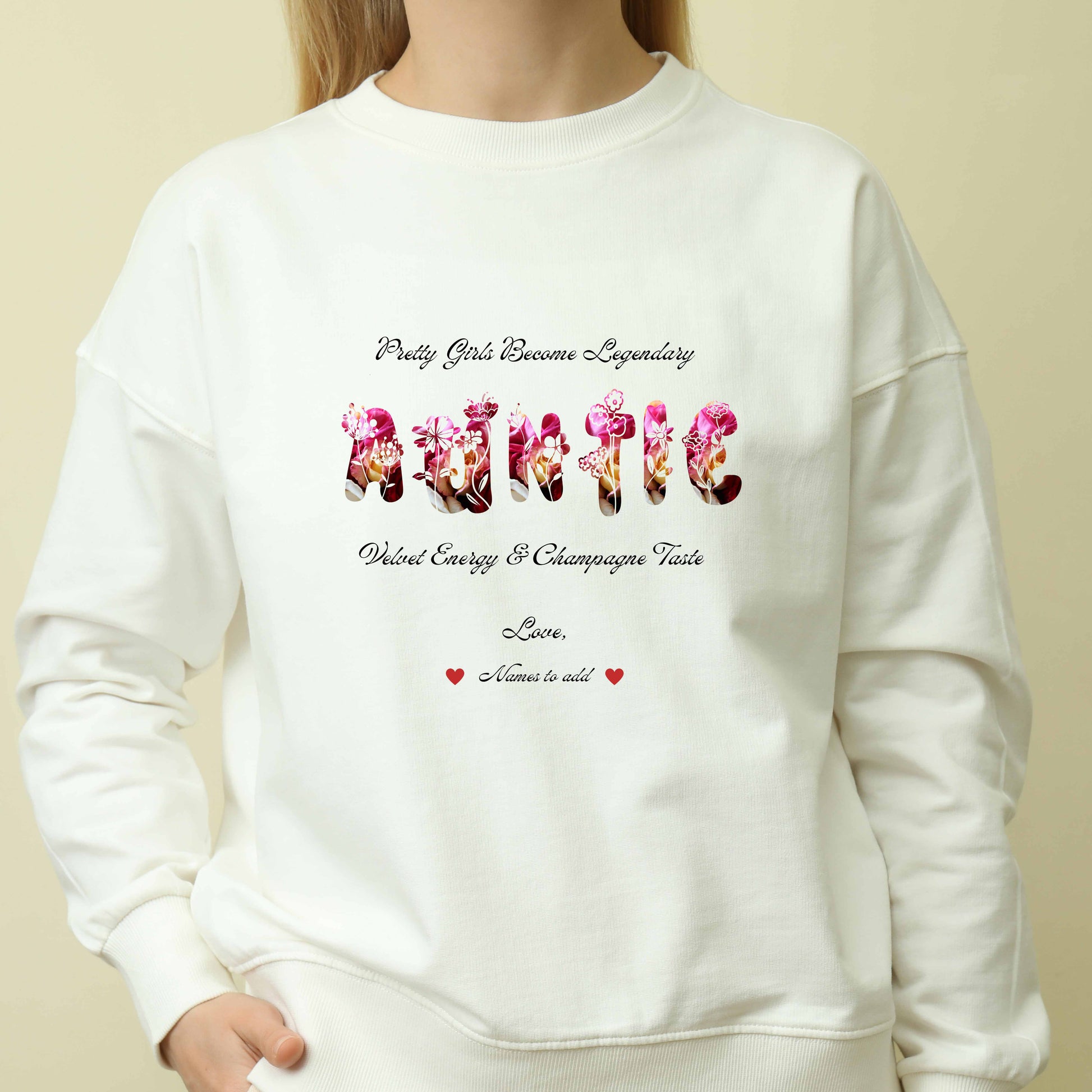 Person wearing a white long sleeve shirt Red long sleeve shirt featuring vibrant flowers, elegant botanical accents, and stylish typography with text and graphics on a beige background