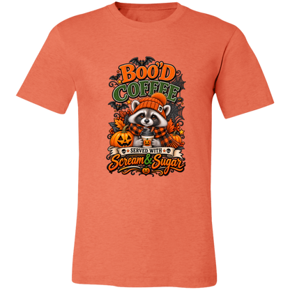 Heather Orange Unisex T-Shirt featuring a Halloween raccoon wearing an orange knit hat and black-and-orange plaid scarf while holding a steaming pumpkin coffee, surrounded by pumpkins, autumn leaves, bats, spiderwebs, and berries, with bold text reading “Boo'd Coffee” and “Served With Scream & Sugar” on a transparent background
