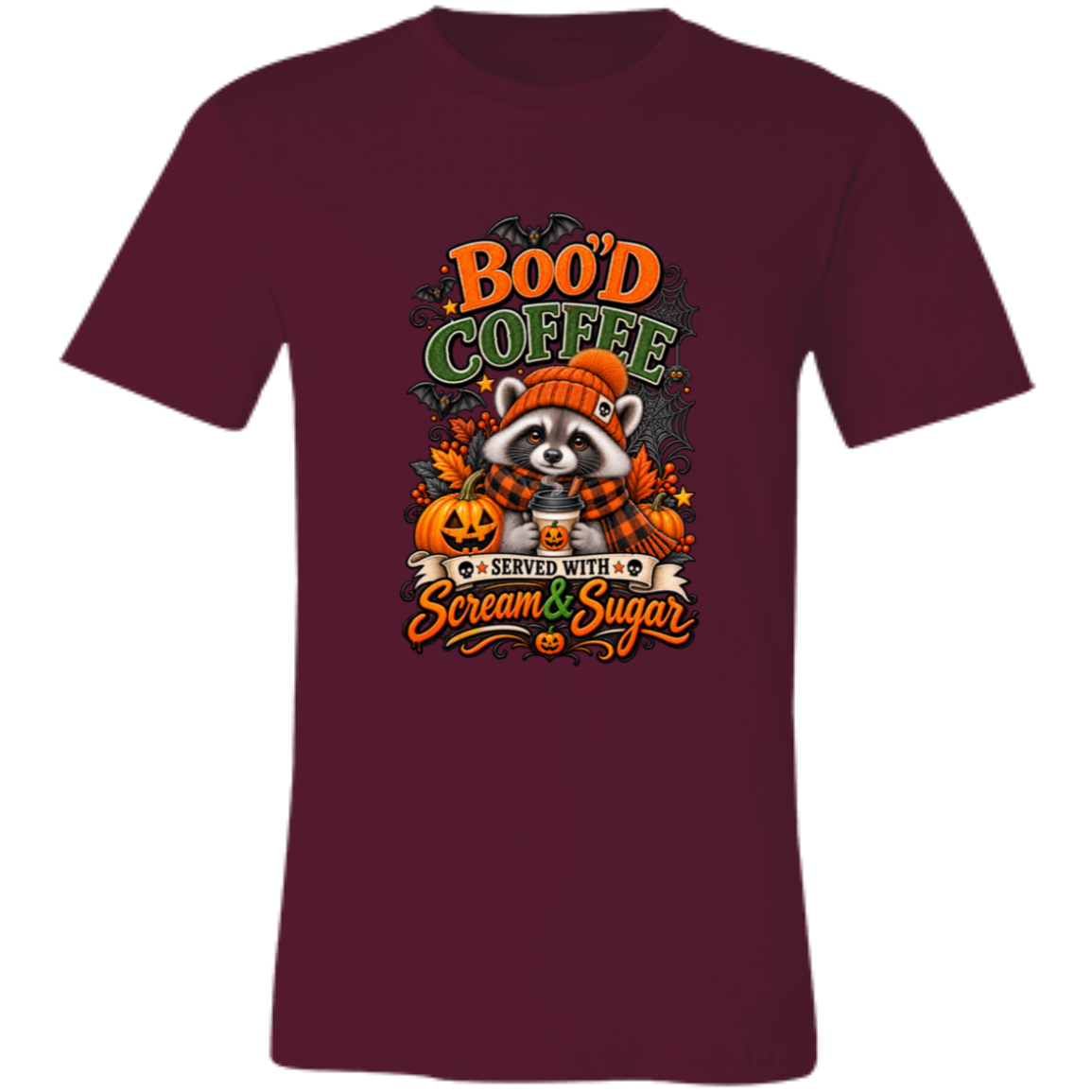 Maroon Unisex T-Shirt featuring a Halloween raccoon wearing an orange knit hat and black-and-orange plaid scarf while holding a steaming pumpkin coffee, surrounded by pumpkins, autumn leaves, bats, spiderwebs, and berries, with bold text reading “Boo'd Coffee” and “Served With Scream & Sugar” on a transparent background