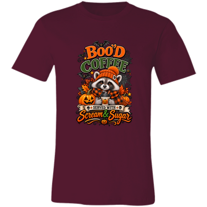 Maroon Unisex T-Shirt featuring a Halloween raccoon wearing an orange knit hat and black-and-orange plaid scarf while holding a steaming pumpkin coffee, surrounded by pumpkins, autumn leaves, bats, spiderwebs, and berries, with bold text reading “Boo'd Coffee” and “Served With Scream & Sugar” on a transparent background