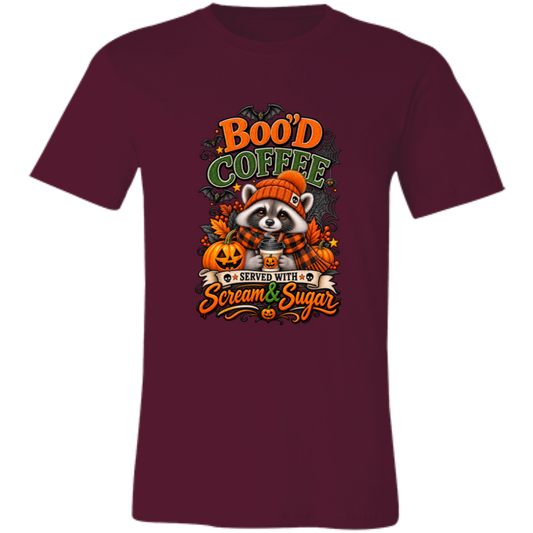 Maroon Unisex T-Shirt featuring a Halloween raccoon wearing an orange knit hat and black-and-orange plaid scarf while holding a steaming pumpkin coffee, surrounded by pumpkins, autumn leaves, bats, spiderwebs, and berries, with bold text reading “Boo'd Coffee” and “Served With Scream & Sugar” on a transparent background