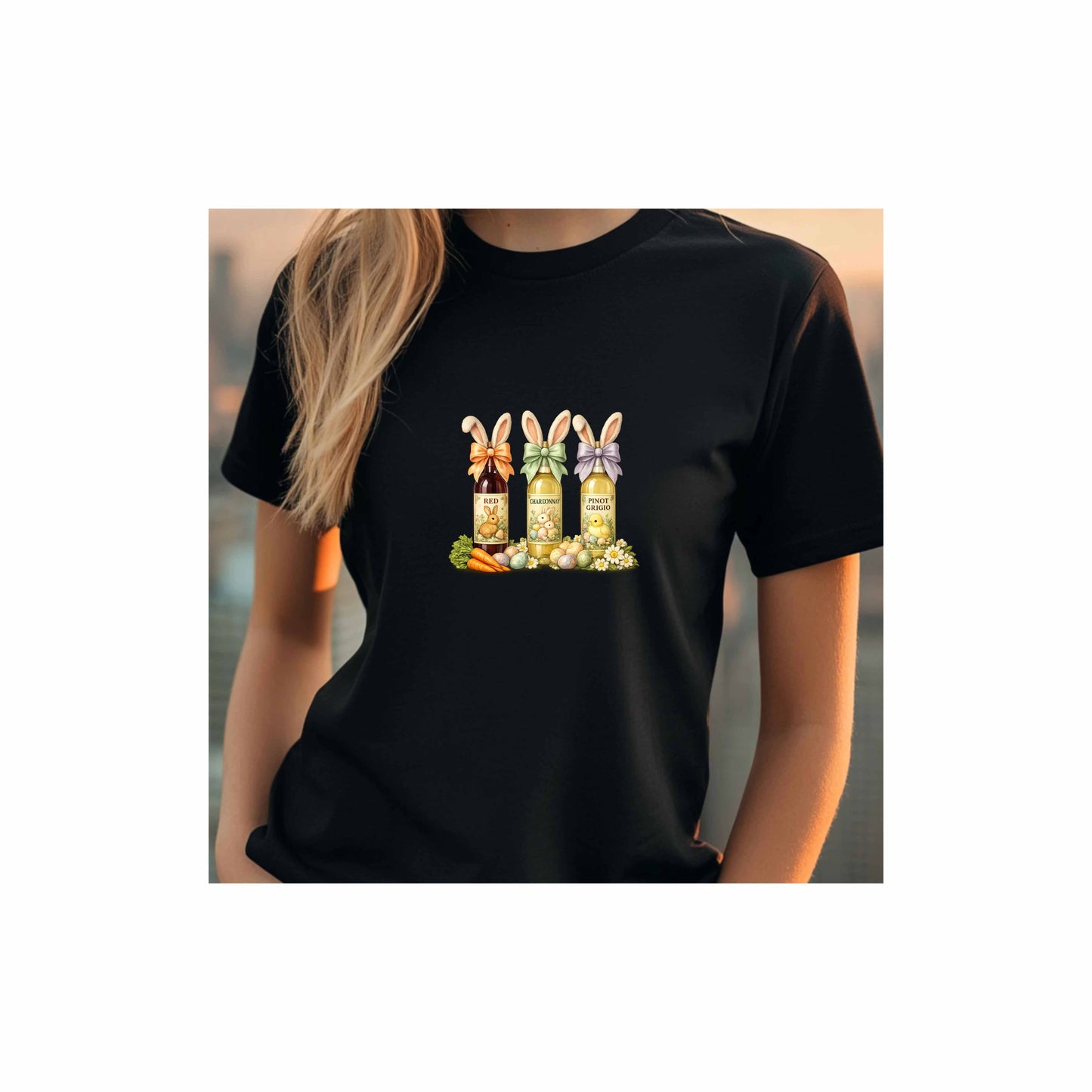 Mock-up photo of a women model from the neck to the waist with blond hair showing a Black t-shirt with a colorful graphic design of three wine bottles (Red, Chardonnay, Pinot Grigio) with bows around the neck of the bottle and bunny ears posed in different positions at the top, flowers, a bunch of carrots and easter designed eggs are at the bottom surrounding the bottoms.