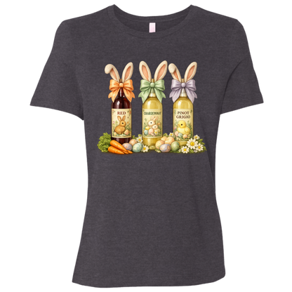 Image of a Dark Gray Heather t-shirt with a colorful graphic design of three wine bottles (Red, Chardonnay, Pinot Grigio) with bows around the neck of the bottle and bunny ears posed in different positions at the top, flowers, a bunch of carrots and easter designed eggs are at the bottom surrounding the bottoms.