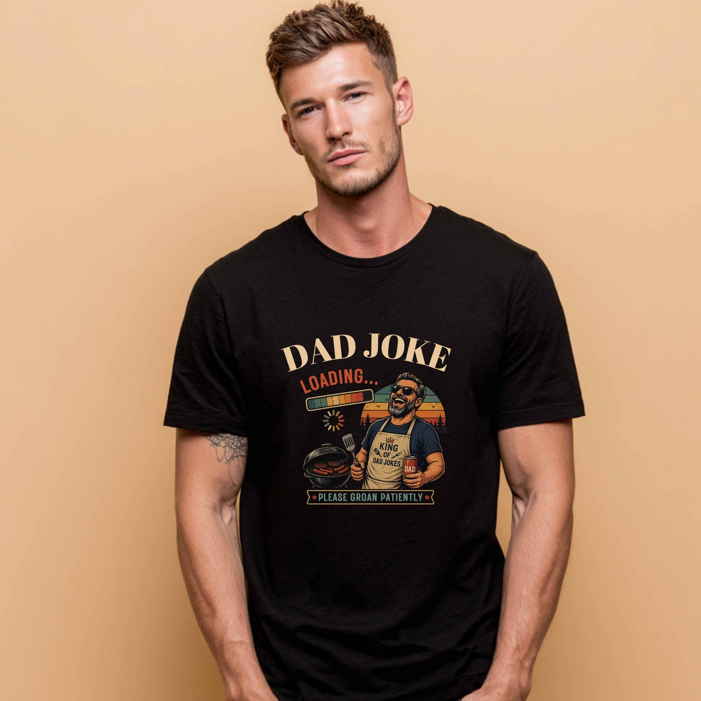AI Generated man wearing a black t-shirt "Dad Joke, Please Groin Patiently" featuring a retro-inspired grilling dad in sunglasses, a vintage sunset backdrop, and a playful loading bar graphic on a beige background