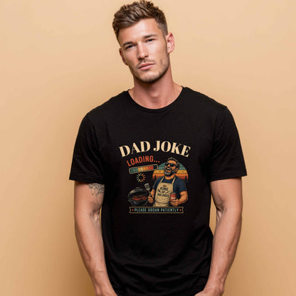 AI Generated man wearing a black t-shirt "Dad Joke, Please Groin Patiently" featuring a retro-inspired grilling dad in sunglasses, a vintage sunset backdrop, and a playful loading bar graphic on a beige background
