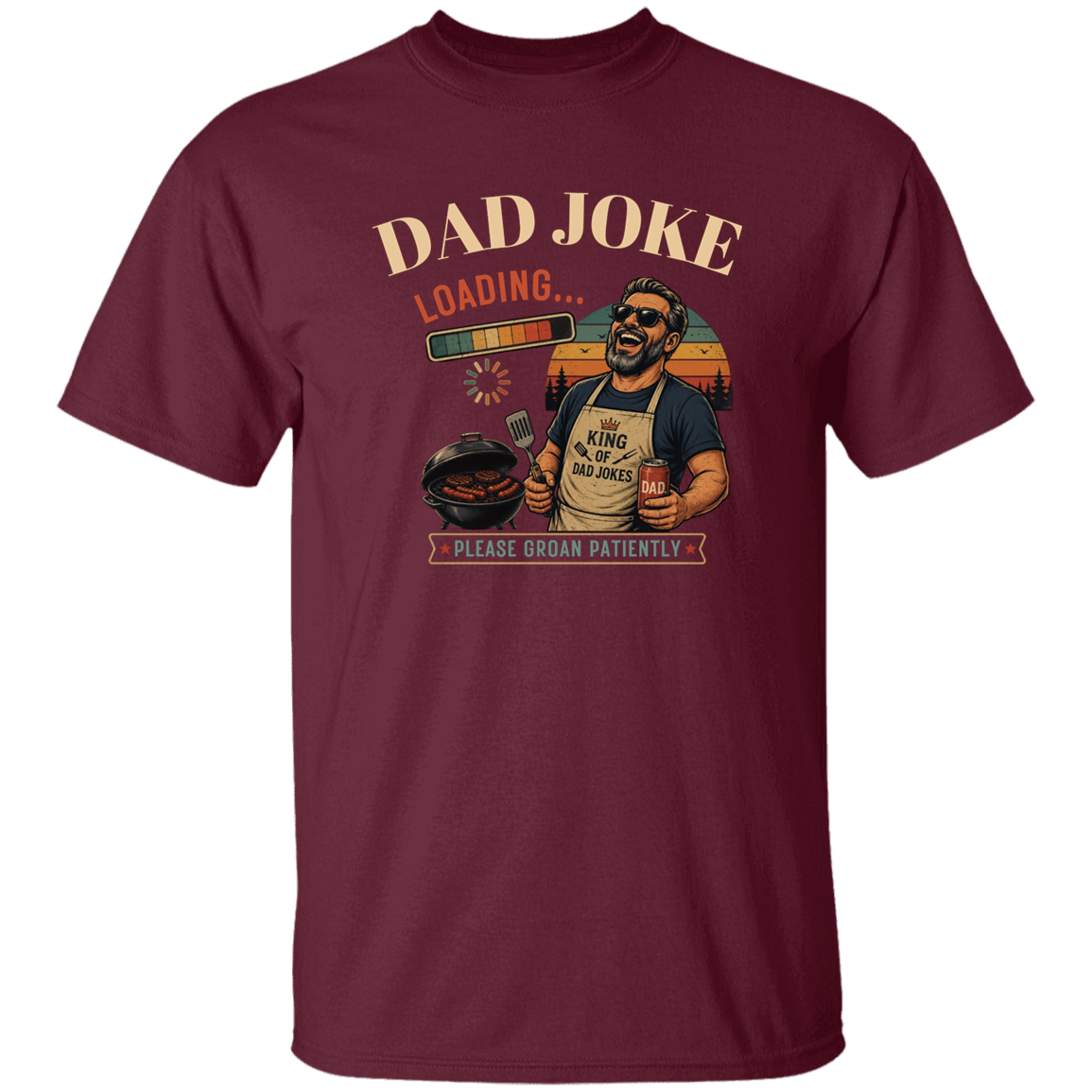 Maroon t-shirt "Dad Joke, Please Groin Patiently" featuring a retro-inspired grilling dad in sunglasses, a vintage sunset backdrop, and a playful loading bar graphic on a gray and black checkerboard background