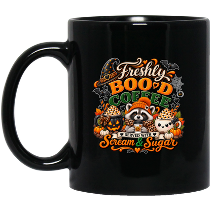 Halloween coffee design mug featuring a cozy raccoon in an orange knit hat and scarf surrounded by pumpkin spice drinks, pumpkins, bats, and autumn leaves, with the text “Freshly Boo'd Coffee” and “Scream & Sugar” on a transparent background