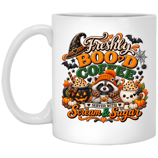 Halloween coffee design mug featuring a cozy raccoon in an orange knit hat and scarf surrounded by pumpkin spice drinks, pumpkins, bats, and autumn leaves, with the text “Freshly Boo'd Coffee” and “Scream & Sugar” on a transparent background