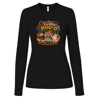 Black Halloween coffee design log sleeve shirt featuring a cozy raccoon in an orange knit hat and scarf surrounded by pumpkin spice drinks, pumpkins, bats, and autumn leaves, with the text “Freshly Boo'd Coffee” and “Scream & Sugar” on a transparent background