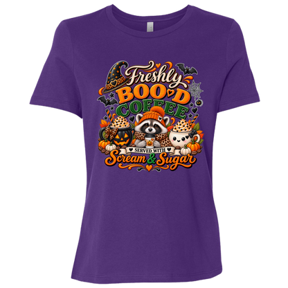 Purple Halloween coffee design t-shirt featuring a cozy raccoon in an orange knit hat and scarf surrounded by pumpkin spice drinks, pumpkins, bats, and autumn leaves, with the text “Freshly Boo'd Coffee” and “Scream & Sugar” on a transparent background
