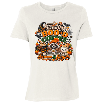 Vintage White Halloween coffee t-shirt design featuring a cozy raccoon in an orange knit hat and scarf surrounded by pumpkin spice drinks, pumpkins, bats, and autumn leaves, with the text “Freshly Boo'd Coffee” and “Scream & Sugar” on a transparent background
