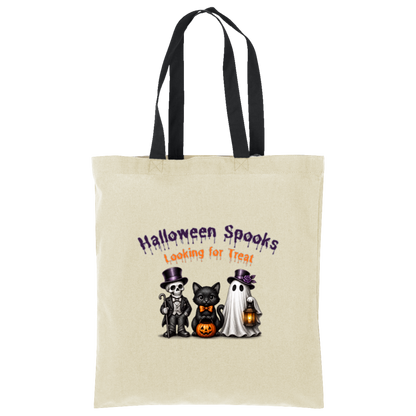 A natural with black straps canvas tote bag with two shoulder straps, featuring a Halloween-themed graphic print on the front. The graphic reads 'Halloween Spooks Looking for Treats' in purple and orange dripping text above three cute cartoon characters: a skeleton in a top hat, a black cat in a bow tie holding a pumpkin, and a white ghost holding a lantern on a transparent background