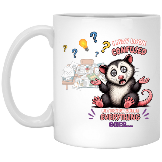 'I May Look Confused But I Know WHere Everything Goes...' hilarious possum perfectly captures that moment when everyone questions your workspace, but you know exactly where every paper, sticky note, and random pen belongs. With its dizzy spiral eyes, overflowing desk, and lovable expression set on a transparent background