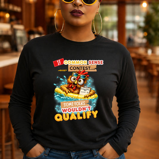 A woman wearing a black long-sleeve graphic t-shirt with a cartoon owl in a yellow raft floating on blue water, with the text 'If COMMON SENSE CONTEST.