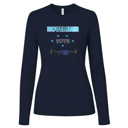 Bold November voting design on a Navy Long Sleeve Shirt featuring large blue gradient “NOVEMBER” lettering at the top, surrounded by blue heart accents. The center features outlined “VOTE” text, while the bottom reads “We are WORTH more than THIS,” with WORTH and THIS highlighted in blue and warm gold decorative accents on both sides. The design has a transparent background and high-contrast outlined typography set on a transparent background