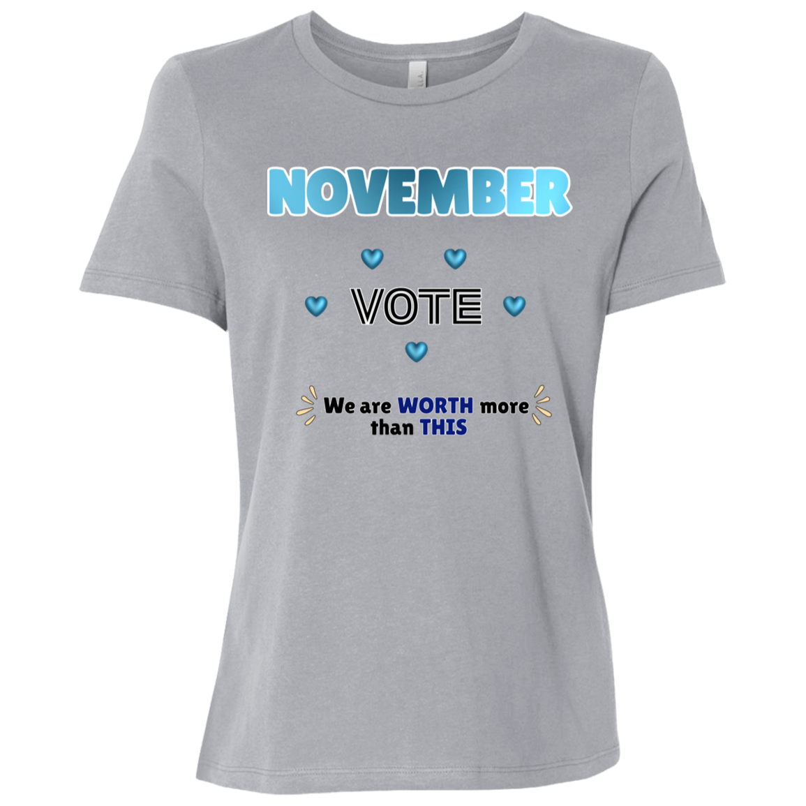 Bold November voting design on a Athletic Grey T-Shirt featuring large blue gradient “NOVEMBER” lettering at the top, surrounded by blue heart accents. The center features outlined “VOTE” text, while the bottom reads “We are WORTH more than THIS,” with WORTH and THIS highlighted in blue and warm gold decorative accents on both sides. The design has a transparent background and high-contrast outlined typography set on a transparent background