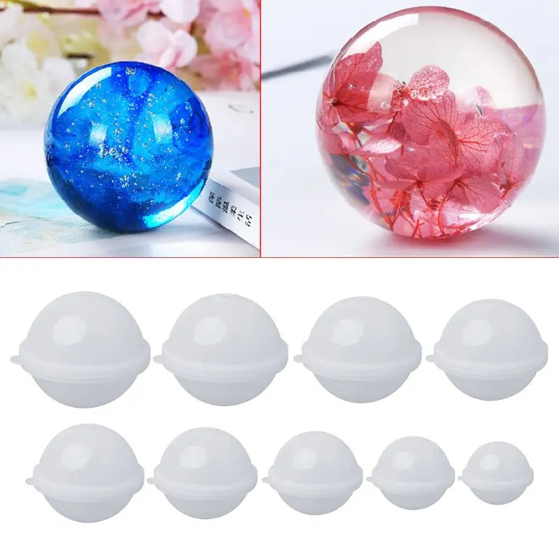 Set of different sized silicone mold balls with two finished products, one blue with something inside and one with pink flowers, on a white background.