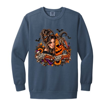 A Blue Jean Sweatshirt featuring a woman in a glamorous Halloween scene surrounded by a decorated jack-o'-lantern, sunflowers, autumn flowers, candles, bats, skulls, and spiderwebs, with a decorative banner reading “Sorta Sweet Sorta Spooky” on a transparent background
