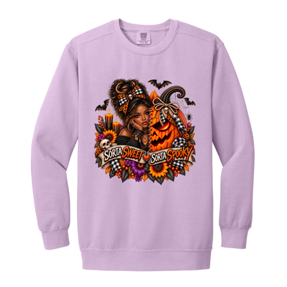 A Orchid Sweatshirt featuring an African American woman in a glamorous Halloween scene surrounded by a decorated jack-o'-lantern, sunflowers, autumn flowers, candles, bats, skulls, and spiderwebs, with a decorative banner reading “Sorta Sweet Sorta Spooky” on a transparent background