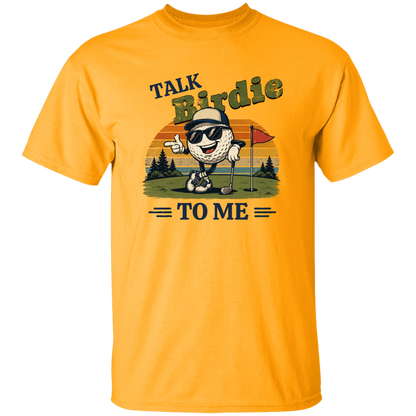 Gold "Talk Birdie To Me" t-shirt on a transparent background featuring a cool cartoon golf ball rocking sunglasses on the green  leaning on a golf club and next to a putting hole with a flag inside of the hole with  a retro sunset background