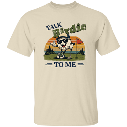 Natural color "Talk Birdie To Me" t-shirt on a transparent background featuring a cool cartoon golf ball rocking sunglasses on the green  leaning on a golf club and next to a putting hole with a flag inside of the hole with  a retro sunset background