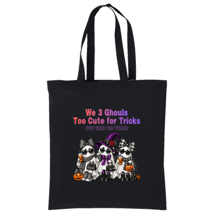 Black bag with three cute ghost friends wearing Halloween accessories with leopard print, buffalo plaid, sunglasses, bows, and a purple witch hat, with orange and purple lettering reading “We 3 Ghouls Too Cute for Tricks” and “Just Here for Treats” on a transparent background